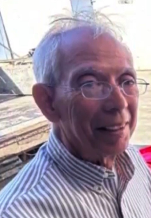 Retrato de un hombre con gafas y camisa de rayas.
